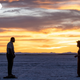 Nine Days stars Winston Duke and Zazie Beetz stand far apart and in shadow in the foreground of a beautiful sunset.